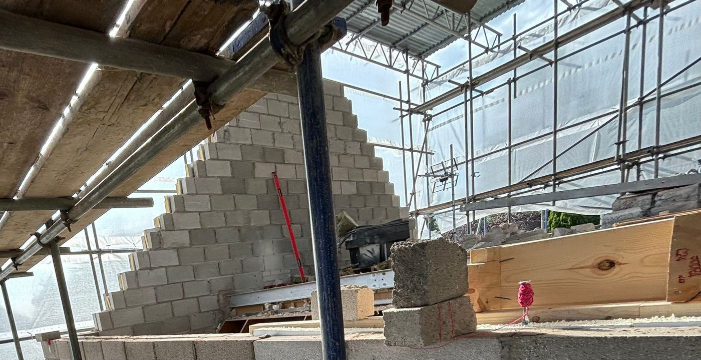 Blockwork gable rising under scaffolding on a RD Construction extension in Aberdare